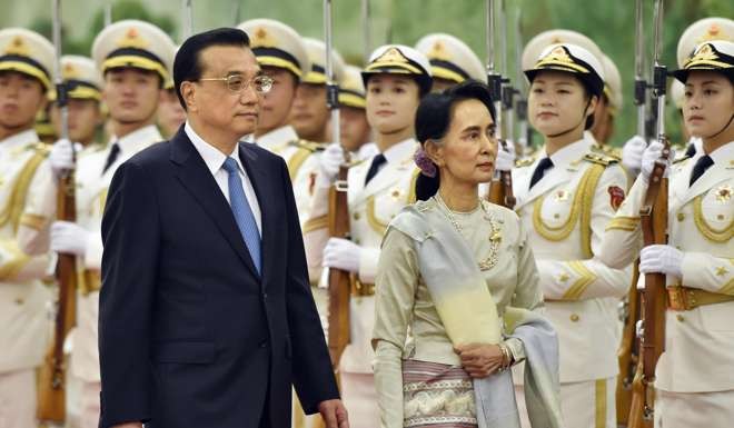 Premier Li Keqiang and Myanmar State Counsellor Aung San Suu Kyi review a guard of honour in Beijing on August 18. In their meeting, Li voiced China’s hopes that Myanmar can find an appropriate solution to the stalled Myitsone dam project. Photo: Kyodo