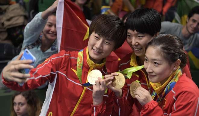 Ding Ning (left), Li Xiaoxia and Liu Shiwen. Photo: AFP