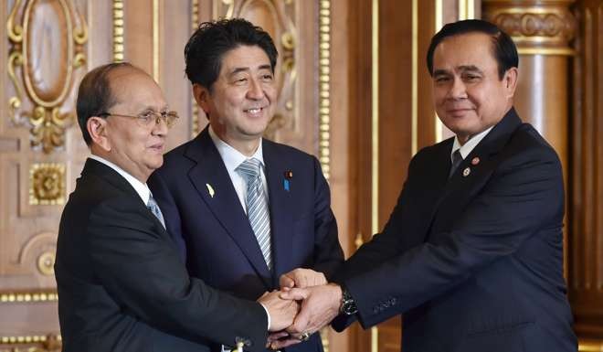 Japanese Prime Minister Shinzo Abe (centre) shakes hands with then Myanmarese president Thein Sein (left) and Thai Prime Minister Prayuth Chan-ocha in Tokyo after the signing ceremony for the Dawei port project in July 2015. Photo: Reuters