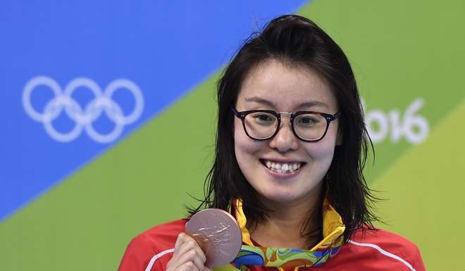 China's Fu Yuanhui poses with her bronze medal on the podium of the Women's 100m Backstroke during the swimming event at the Rio 2016 Olympic Games. Photo: AFP