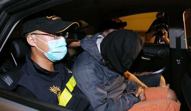 A suspect is driven away after officers discovered liquid cocaine inside hollowed out dragon fruits. Photo: SCMP Pictures