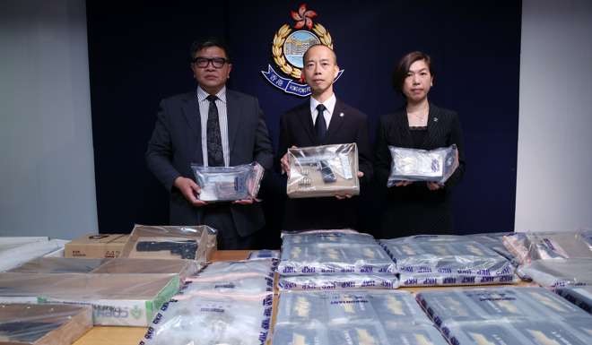 Police officers display some of the items they seized during an operation to seize 95kg of cocaine near the border. Photo: Sam Tsang