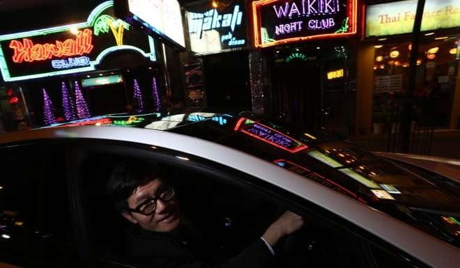 Hong Kong Uber driver Timmy Cheng Tak-tim, as he navigates the streets of Wan Chai in March. Photo: Jonathan Wong