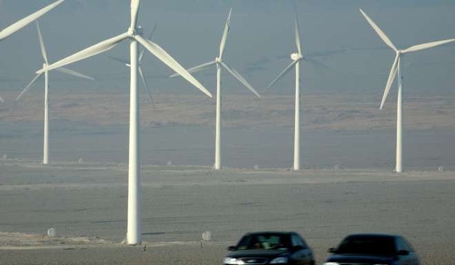 A wind farm alongside a highway in Turpan, in the Xinjiang region. In drawing up its energy road map, Hong Kong needs to take into account the future direction of the mainland. Photo: AFP