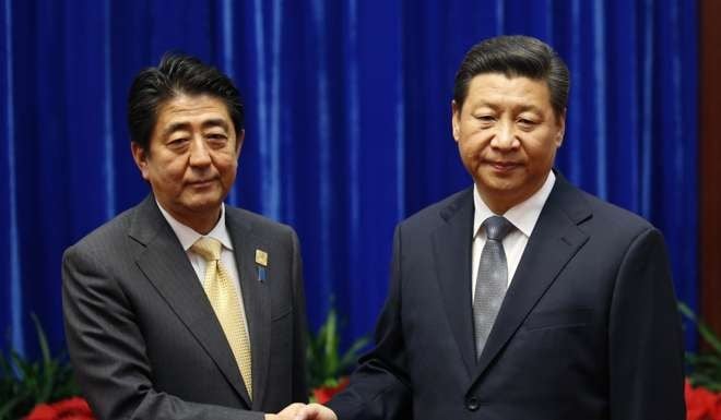 Sunday’s meeting of the two leaders were markedly different from when Shinzo Abe (left) met Xi Jinping on the sidelines fo the Asia-Pacific Economic Cooperation forum in Beijing two years ago. Photo: Reuters