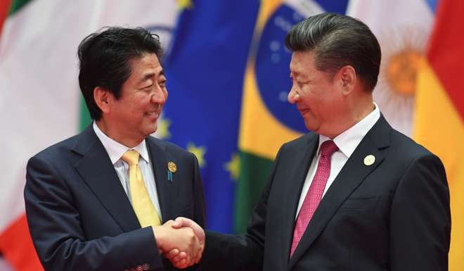 Japanese Prime Minister Shinzo Abe (left) with President Xi Jinping in Hangzhou on Sunday. Photo: AFP