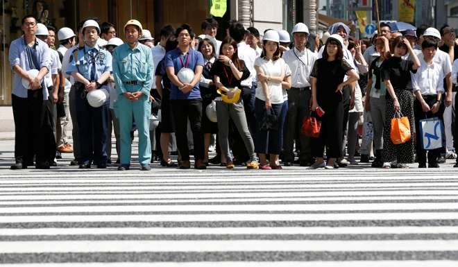 People with helmets take part in an earlier drill simulating a 7.2 magnitude earthquake in Tokyo on August 26. Photo: Reuters