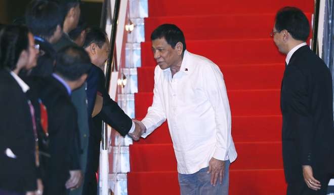Philippine President Rodrigo Duterte (C) disembarks a plane upon his arrival to attend the 28th and 29th ASEAN Summits and Related Summits at the airport in Vientiane, Laos. Photo: EPA