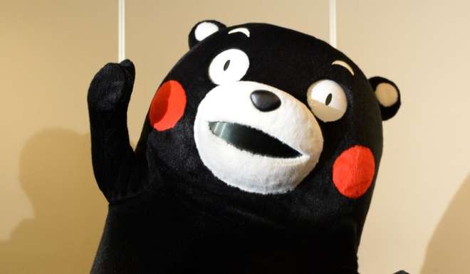 Kumamon, a clumsy bear mascot of Kumamoto prefecture performing his dance during a press conference. Photo: AFP