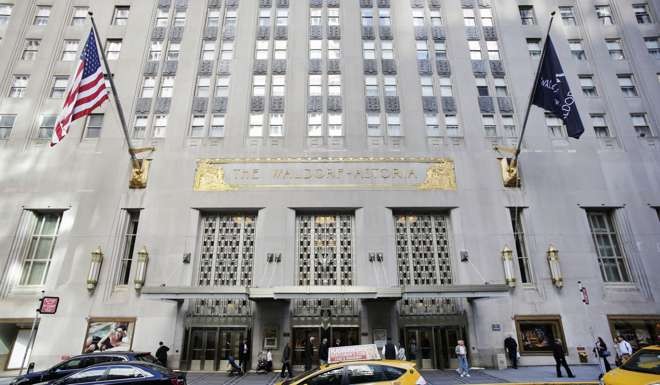 A taxi passes in front of the fabled Waldorf Astoria hotel in New York, which was acquired by Chinese insurance conglomerate Anbang. Photo: AP