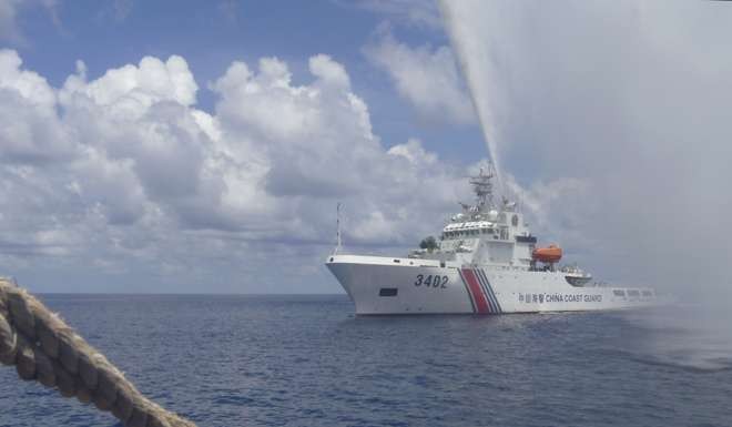 China’s coastguard boat sprays a water cannon at Filipino fishermen near Scarborough Shoal in the disputed South China Sea on September 23, 2015. Photo AP