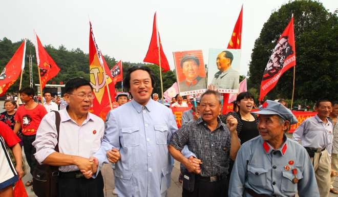 People stand beside a Mao Zedong impersonator in Shaoshan on Friday. Photo: Simon Song