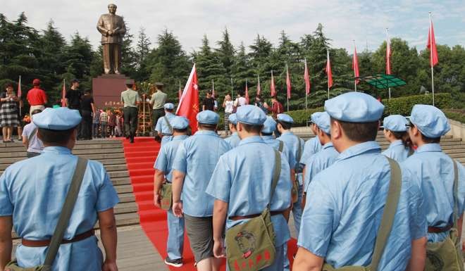 Dressed in Red Army suits, people pay tribute to Mao Zedong at the Mao Zedong Square in Shaoshan. Photo: Simon Song
