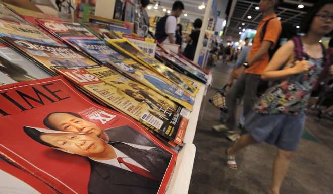 A copy of Time magazine features portraits of Chinese leader Xi Jinping and former leader Mao Zedong at an annual book fair in Hong Kong. Photo: AP