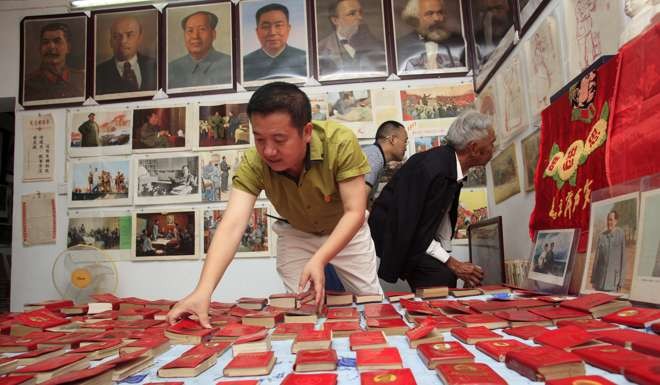 A man arranges his collections of Chairman Mao's ‘little red book’ at a ’red museum’ in his home in Yichang, Hubei Province. President Xi said he read the book every night during the revolution. Photo: Reuters