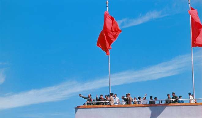 Chairman Mao Zedong waves to Red Guards from the Tiananmen Rostrum in Beijing in 1966. Photo: China Foto Press