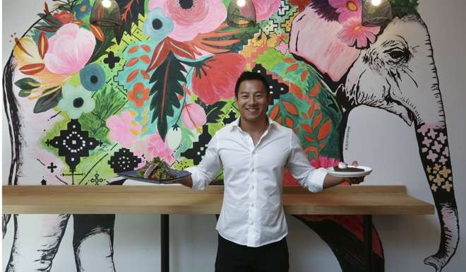 Ricky Cheuk, founder of The Warrior Academy, shows off dishes from its restaurant. Photo: Jonathan Wong