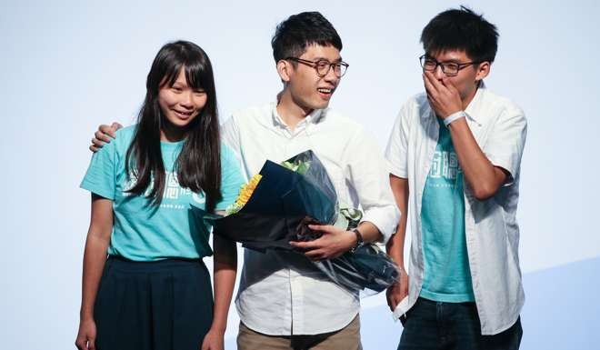 Nathan Law (centre) celebrates with fellow Demosisto members Agnes Chow and Joshua Wong after winning a Legco seat on September 5. Photo: Dickson Lee