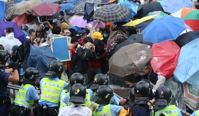 Protesters use umbrellas as shields against pepper spray amid scuffles with police in Admiralty after Occupy Central was officially launched on September 28, 2014. Photo: K.Y. Cheng
