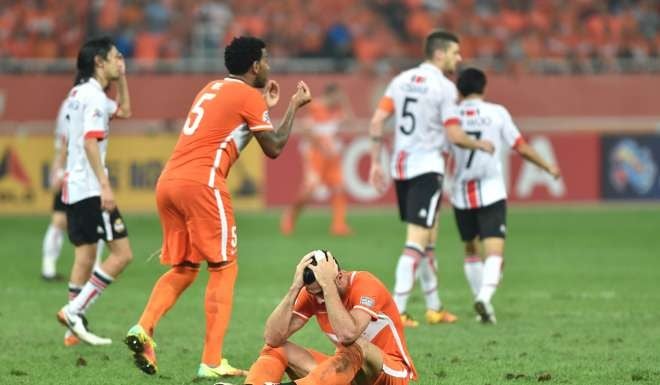 Carlos Silva gestures as teammate Graziano Pelle holds his head in his hands in disappointment after Shangdong Luneng are eliminated. Photo: Xinhua