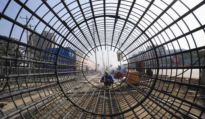 A worker welds steel bars at a construction site in Hefei, Anhui province. Photo: Reuters