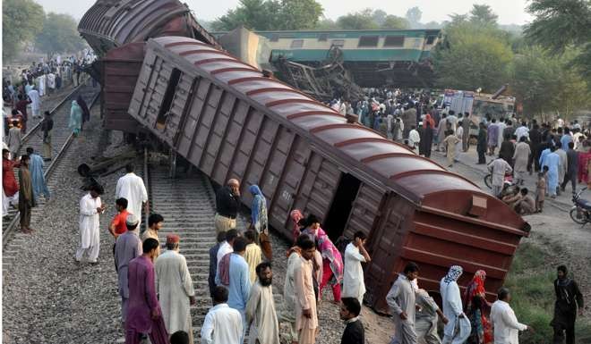 Locals gather at the scene where two trains collided near Multan, Pakistan. Photo: Reuters