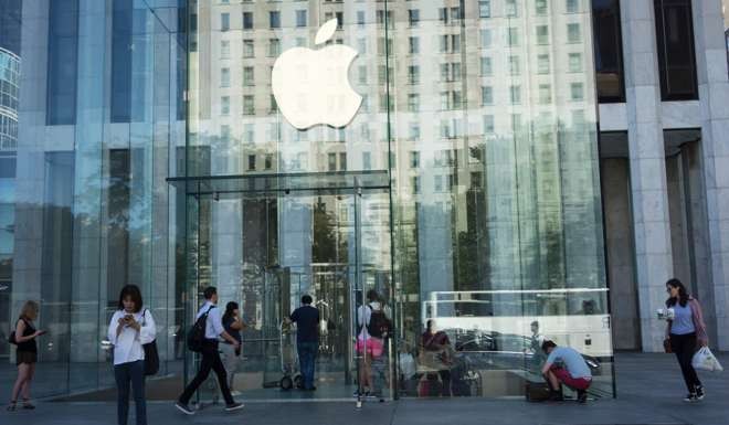 The Apple logo at the entrance to the Fifth Ave. Apple store in New York City. Photo: AFP