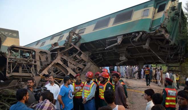 Rescue workers and people gather at the scene of a train accident near Buch station. Photo: EPA