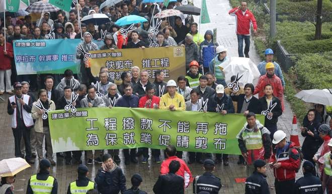 Construction industry representatives rally against filibustering outside the Legislative Council complex in Tamar on March 13. Photo: Dickson Lee