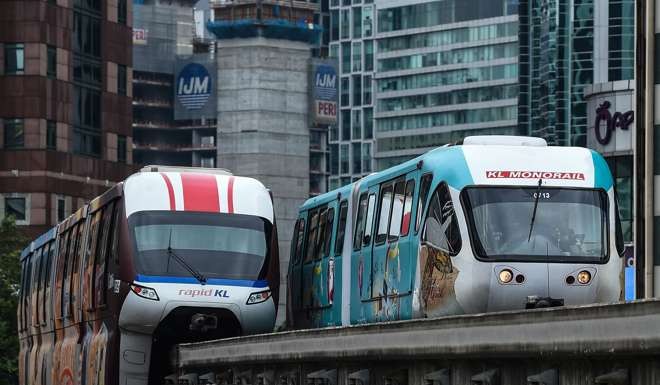 Monorail trains pass each other near the Bukit Bintang station in downtown Kuala Lumpur. The real bond yield differentials for Malaysia, Indonesia, Korea and Taiwan are near their one-year widest points. Photo: AFP