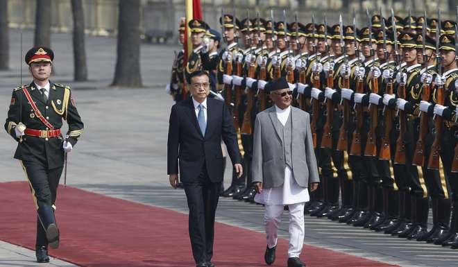 Premier Li Keqiang accompanies then Nepali prime minister K.P. Oli to view an honour guard outside the Great Hall of the People in Beijing on March 21. Oli often played the China card to play on Delhi’s insecurities. Photo: EPA