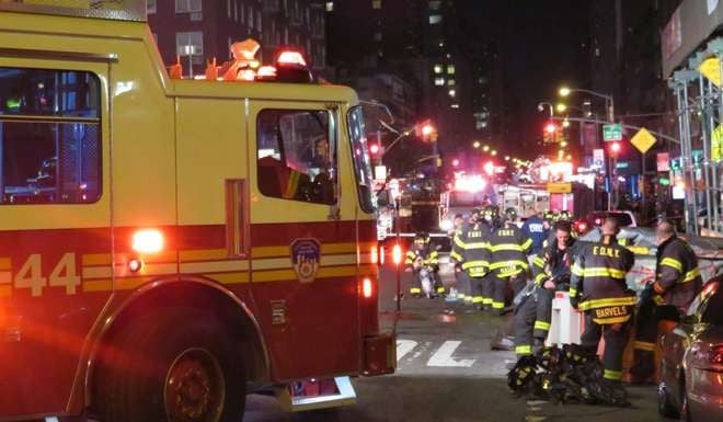 Firefighters near the site of an explosion in Manhattan. Photo: Kyodo