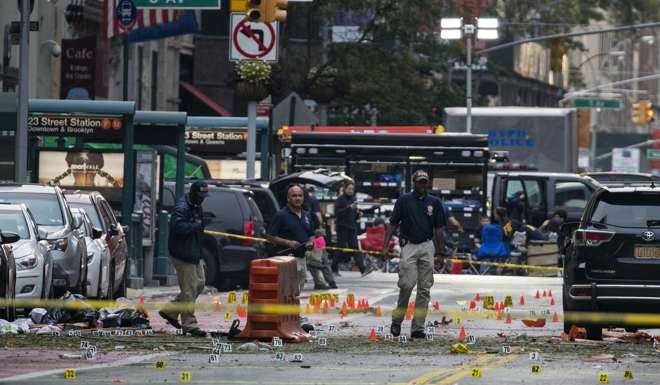 Crime scene investigators work at the scene of the explosion in Manhattan. Photo: AP