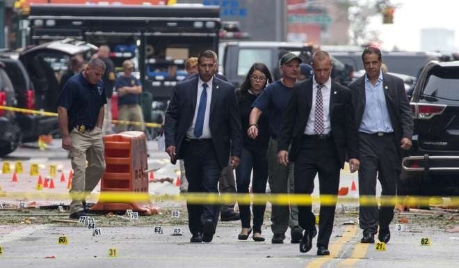 New York Governor Andrew Cuomo (right) walks from the scene of an explosion on West 23rd street in Manhattan's Chelsea neighbourhood. Photo: AP