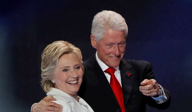 Former US president Bill Clinton stands by wife Hillary after she accepted the Democratic nomination on the final night of the party’s National Convention in Philadelphia on July 28. Photo: Reuters
