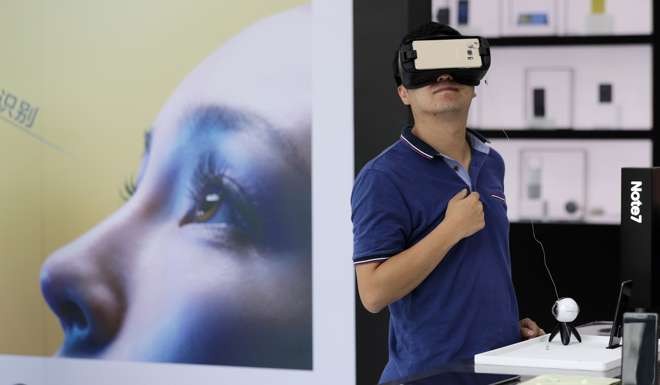 A man tries out the Samsung VR using their latest Galaxy Note 7 smartphone at a roadshow outside a shopping mall in Beijing. Photo: AP