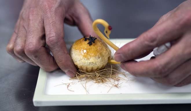 Master chef Justin Tan prepares a dessert in his kitchen at the T'ang Court restaurant in Shanghai. Photo: AFP