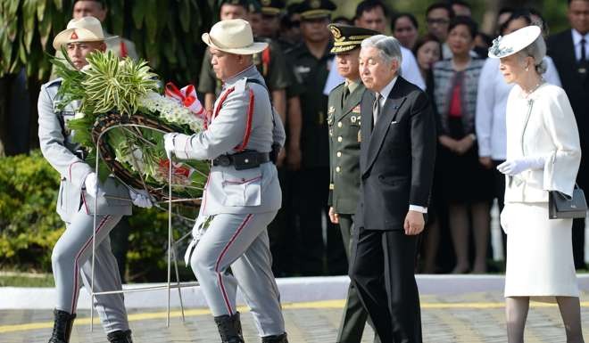 Japanese Emperor Akihito and Empress Michiko follow Philippine soldiers carrying a wreath to the tomb of the unknown soldier at the national cemetery in Manila on January 27, on a historic visit to promote Akihito’s pacifist agenda. Photo: AFP