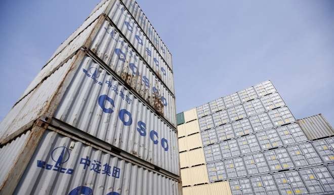 Containers from China Ocean Shipping Company (COSCO) at a port in Shanghai, China. Policy makers must assess factors such as economics, technology, governance and environment when assessing trade routes. Photo: Reuters