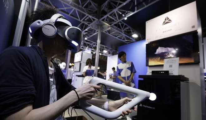 A gamer wears a virtual reality headset to play a video game at the Tokyo Game Show Photo: Bloomberg