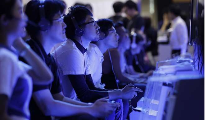 Gamers using PlayStation 4 consoles at Tokyo Game Show 2016. Photo: Bloomberg