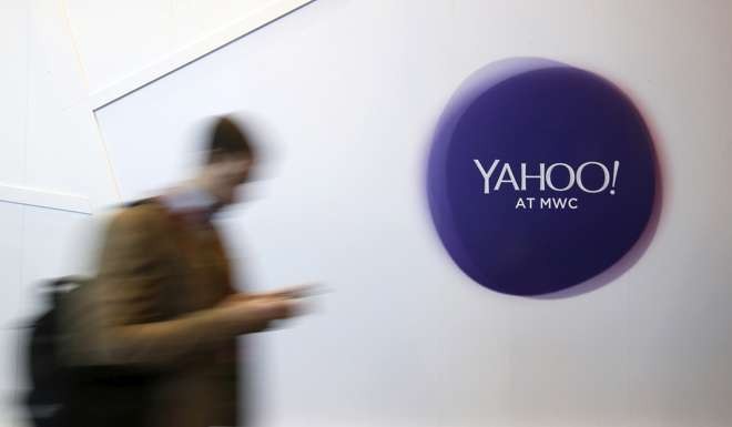 A man walks past a Yahoo logo during the Mobile World Congress in Barcelona, Spain. Photo: Reuters