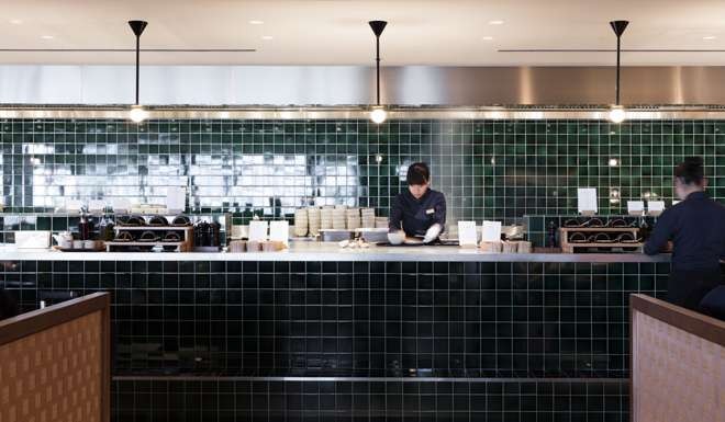 The signature noodle bar is distinctive with its ceramic green tiles and open kitchen. Photo: StudioIlse