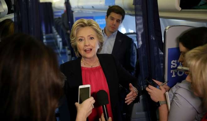 Democratic presidential nominee former Secretary of State Hillary Clinton speaks to reporters aboard her campaign plane before departing from Westchester County Airport on September 27, 2016 in White Plains, New York. Photo: AFP