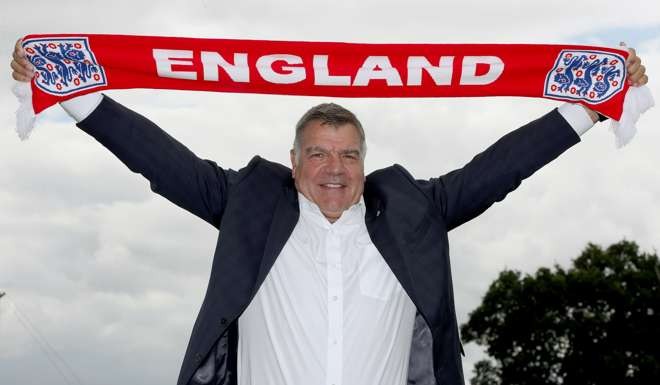 Then newly appointed England manager Sam Allardyce displays an England scarf. Allardyce has left his position after one match in charge of national team. Photo: PA via AP