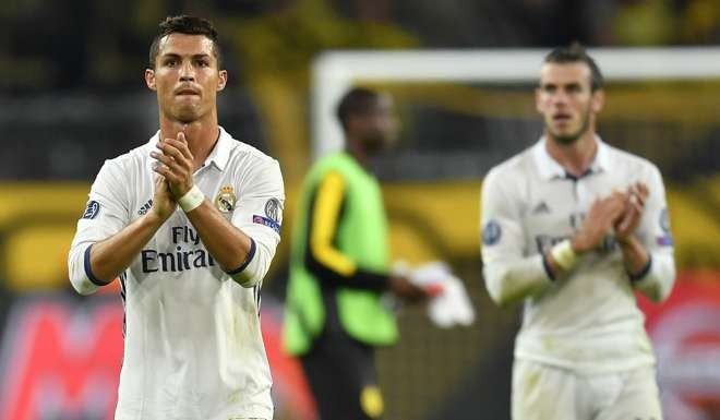 Real Madrid's Cristiano Ronaldo and Gareth Bale, right, acknowledge the fans after the Champions League group F soccer match between Borussia Dortmund and Real Madrid in Dortmund, Germany, Tuesday, Sept. 27, 2016. (AP Photo/Martin Meissner)