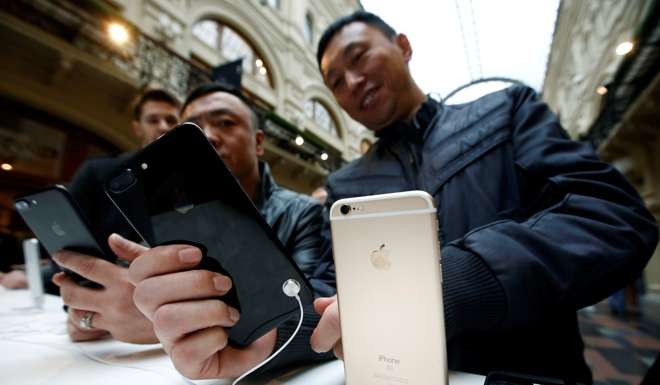 Customers gather at a store selling Apple products during the launch of the new iPhone 7 sales at the State Department Store, GUM, in central Moscow, Russia. Photo: Reuters