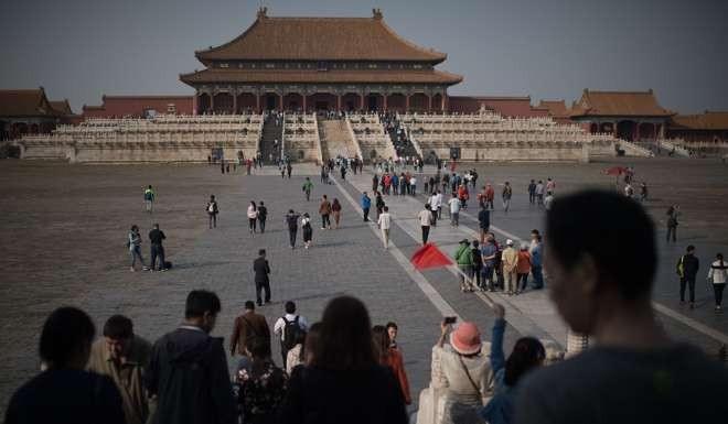 Visitors to the Forbidden City in Beijing take in the sights. The West is bedazzled by China’s mysticism and bigness. Photo: AFP