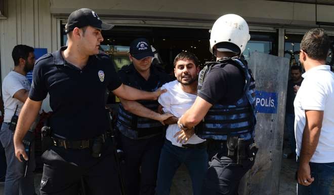 Turkish police officers detain a man in during a protest. Photo: AFP