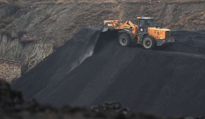 A front end loader drops a load of coal near a coal mine in China. Photo: AFP